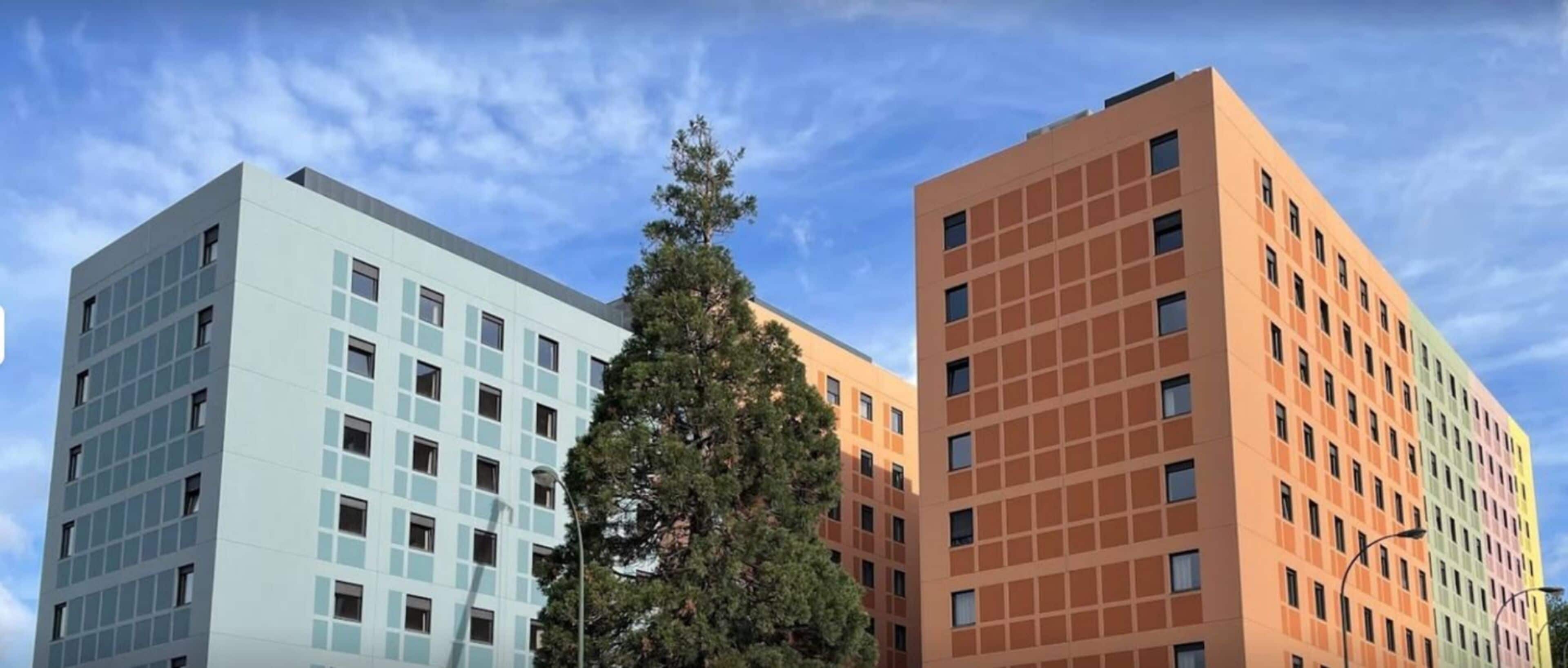 A modern building with a grid of windows and a flat roof.