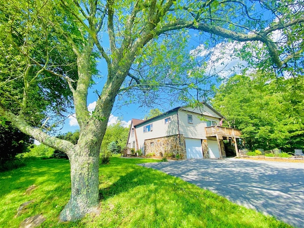 A two-story house with a stone facade, a garage, and a covered porch.