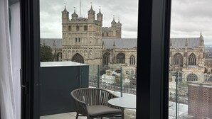 A room with a view of a historic building with multiple towers and arched windows. - Hotel Indigo Exeter by IHG (Exeter)
