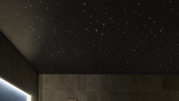 A spa area with two hot tubs, a starry ceiling, and framed artwork on the wall. - Hotel Indigo Exeter by IHG (Exeter)