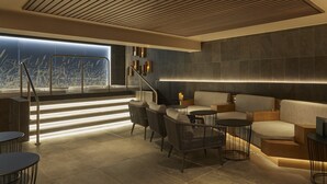 A modern lounge area with a staircase, seating, and a view of the city. - Hotel Indigo Exeter by IHG (Exeter)