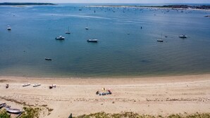A beach with boats and a sandy shore.