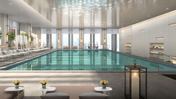 A modern indoor swimming pool with lounge areas, seating, and a view of the city. - Four Points By Sheraton Tianjin National Convention And Exhibition Center (Tianjin)