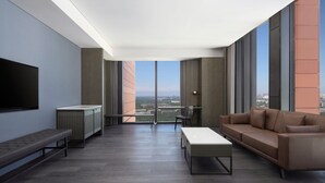 A modern living room with a large window, a sofa, a coffee table, and a bench. - Four Points By Sheraton Tianjin National Convention And Exhibition Center (Tianjin)
