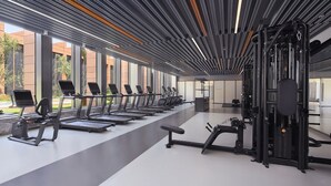 A modern gym with treadmills, elliptical machines, and weightlifting equipment. - Four Points By Sheraton Tianjin National Convention And Exhibition Center (Tianjin)