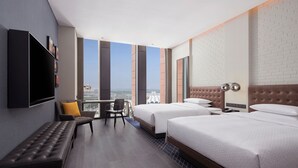A hotel room with two beds, a bench, a desk, and a TV. - Four Points By Sheraton Tianjin National Convention And Exhibition Center (Tianjin)