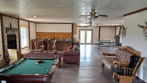 A spacious indoor area with a pool table, a fireplace, and a dining table. - Hacienda Roja - The Juniper #5 at Wind Walker Homestead (Spring City)