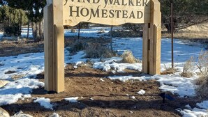 A wooden sign with the text "Wind Walker Homestead" in a rural setting with snow on the ground and trees in the background. - Hacienda Roja - The Sage #6 at Wind Walker Homestead (Spring City)