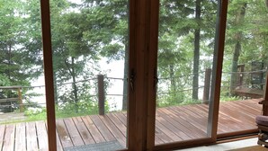 A room with a large sliding glass door leading to a wooden deck. - Fence Lake Retreat w/ dock (Lac du Flambeau)