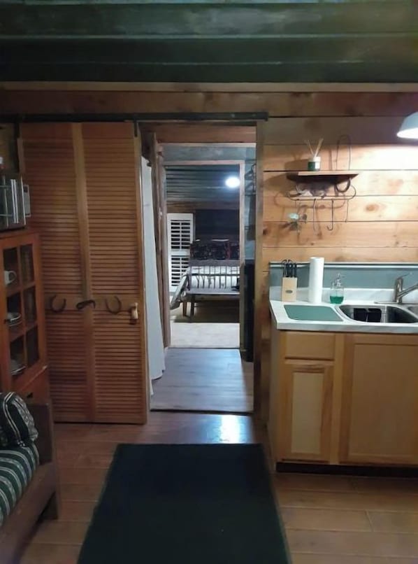 A cozy kitchen with wooden cabinets and a countertop.