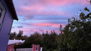 A backyard with a swimming pool, a white picket fence, and a small shed. - 3 bedroom home with pool (Sandys)
