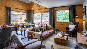 A cozy cabin interior with a wooden interior, a dining area, and a sofa set. - Solly Nook - alpine holiday for 8, hot tub & close to action - OVO Network (Châtel)