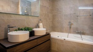 A modern bathroom with two sinks, a bathtub, and a glass shelf above the sinks. - Solly Nook - alpine holiday for 8, hot tub & close to action - OVO Network (Châtel)