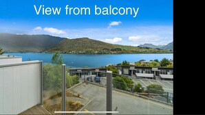 A view from a balcony overlooking a lake with mountains in the background. - 2-BEDROOM APARTMENT - BEECHWOOD (Queenstown)