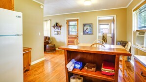 A kitchen with wooden cabinets, a dining table, and a refrigerator. - Welcoming Biggers Home - Great Duck Hunting! (Biggers)