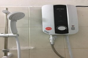 A wall-mounted JTEC shower unit with a handheld showerhead, connected to a flexible hose. - Hoang Nam Hotel by Zuzu (Ho Chi Minh Municipality)