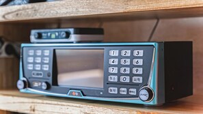 Een klein, smaragdgroen draagbaar muziekapparaat met een groot scherm en een numeriek keypad.