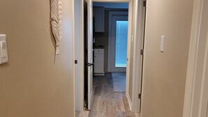 A hallway with wooden flooring, beige walls, and a decorative leaf carving. - Beach front cottage - don't let the outside fool you - check out the photos!  (Fernandina Beach)