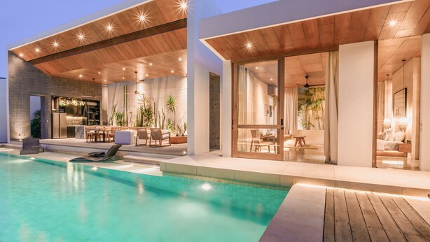 A modern house with a swimming pool, wooden ceiling, and large windows. - Villa Boya (Canggu)