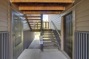 Stairs lead to the entrance of this building, flanked by two doors.