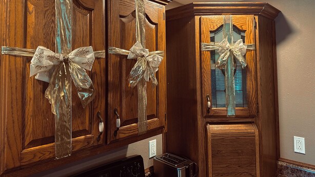 A kitchen with wooden cabinets, a toaster, and a dishwasher. - Lake Road Cabin C — Million Dollar Ozark View! (Ironton)
