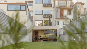 A modern residential building with a flat roof, large windows, and a balcony. - Legacy Oporto Premium Apartment B by Vacationy (Porto)