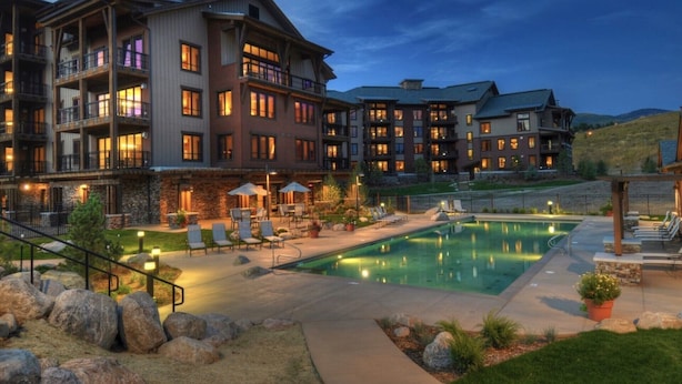 A multi-story hotel with outdoor pools and lounge areas. - First Tracks Condo w/ Gondola Access & Pool 1054 (Steamboat Springs)