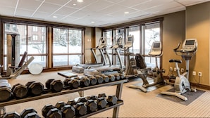 A gym with various exercise equipment, including treadmills, elliptical machines, and dumbbells. - First Tracks Condo w/ Gondola Access & Pool 1054 (Steamboat Springs)