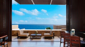 A modern outdoor seating area with a view of the ocean. - Casa Maat At JW Marriott Los Cabos Beach Resort & Spa (San José del Cabo)