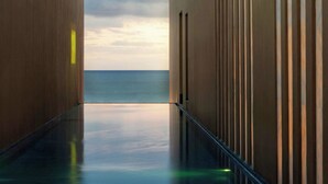 A modern building with a reflective floor leading to a view of the sea. - Casa Maat At JW Marriott Los Cabos Beach Resort & Spa (San José del Cabo)