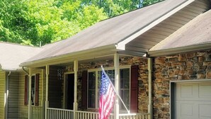 A two-story house with a stone facade and a covered porch. - BICKING & Fishing, National Parks .Water park. Shooting. Gamblingnd. IPA at PA.  (Clifton)