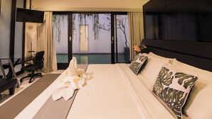 A hotel room with a bed, a desk, a chair, and a TV. - Free Rooms!   Seminyak Bali Modern Walk to Beach Shopping New and Clean (Bali)