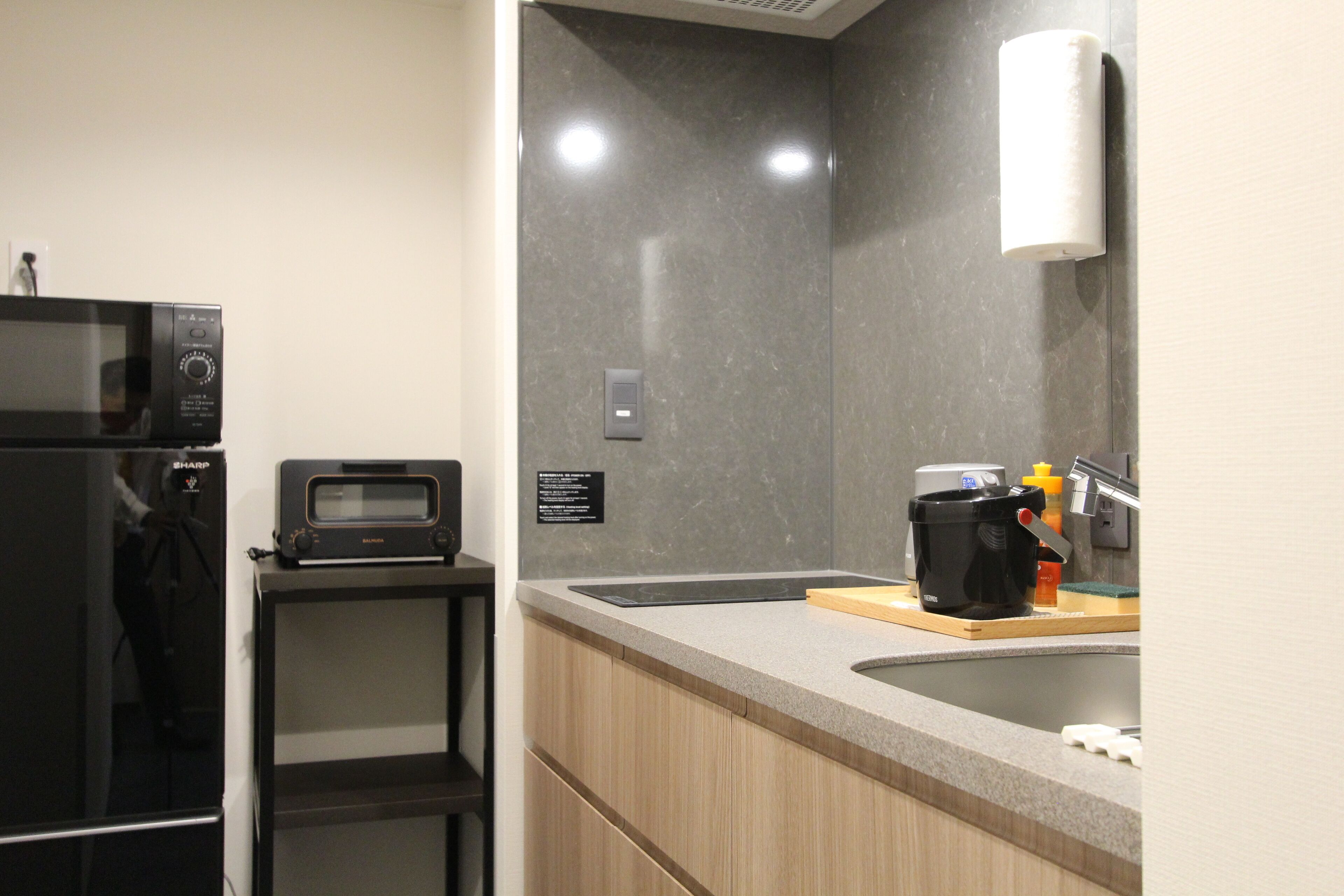 A modern kitchen with a microwave, toaster, and coffee maker on the counter.