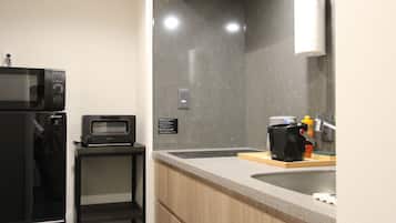 A modern kitchen with a microwave, toaster, and coffee maker on the counter.