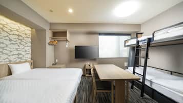 A hotel room with two beds, a desk, a TV, and a wardrobe.