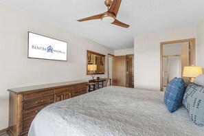 A bedroom with a bed, dresser, mirror, and ceiling fan. - Amazing Lake View Walk-In Condo, Newly Renovated Spacious Near Silver Dollar City with Free Tickets (Branson)