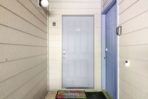 A door with a number 7, a blue door to the right, and a welcome mat at the entrance. - Amazing Lake View Walk-In Condo, Newly Renovated Spacious Near Silver Dollar City with Free Tickets (Branson)