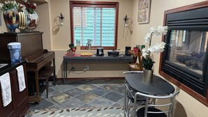 A kitchen with a dining area, a coffee maker, a toaster, and a window with blinds. - Home: Sleeps 4, Bedroom, Living, Bath, Office, Patio (Bothell)