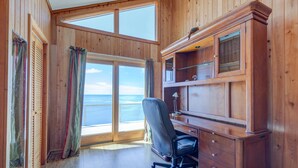 A wooden-paneled room with a large window, a desk, and a chair. - 7815-Tarhoo, | Soundfront Frisco Retreat | Pool & Sunset Views (Frisco)