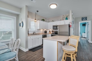 Enjoy casual dining in this kitchen with a central island, sink, and stainless steel appliances.
