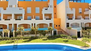 A modern hotel with a pool, featuring a multi-story structure with balconies and a well-maintained garden. - Marvel Apartment with Pool near Playa Vera (Vera Playa)