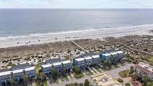 A coastal hotel with multiple-story buildings, a sandy beach, and a view of the ocean. - Lovely Beach house in Amelia for 8 (Fernandina Beach)