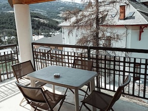 Enjoy a meal on the balcony with a view of the surrounding cityscape.