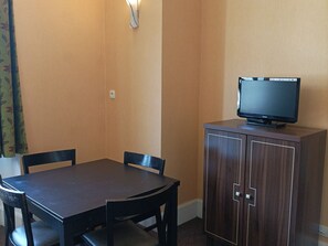 Relax in this cozy space with a flat-screen TV and a comfortable seating area.