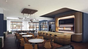 A modern bar area with a wooden counter and seating for guests. - Courtyard Austin Dripping Springs (Dripping Springs)