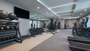 A modern gym with treadmills, weight machines, and free weights. - Courtyard Austin Dripping Springs (Dripping Springs)