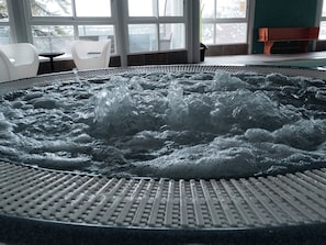 A hot tub with a textured surface and a grid pattern around its edge.