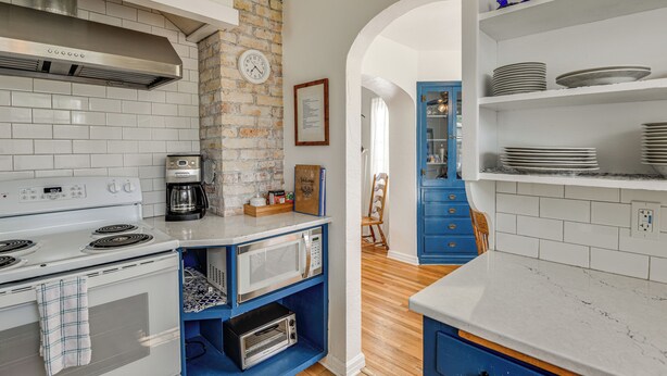 A kitchen with a white stove, a coffee maker, and a microwave on a blue shelf. - 6 Mi to Shoshone Falls! Charming Idaho Home (Twin Falls)