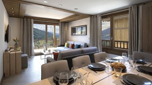 A modern hotel room with a balcony, a dining area, and a sofa. - MGM Hôtels & Résidences – Résidence Chalets de Joy (Le Grand-Bornand)