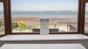 A view from a window with a sign listing beach house rules. - Waters Edge (Stranraer)
